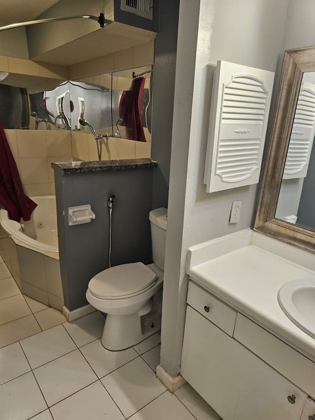 bathroom with tile floors, toilet, and vanity