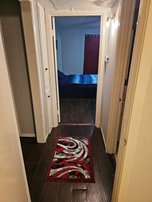 corridor featuring dark wood-type flooring