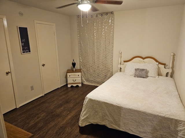 bedroom featuring ceiling fan and dark hardwood / wood-style floors