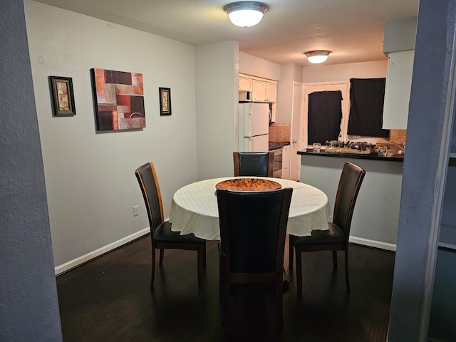 dining area featuring dark hardwood / wood-style flooring