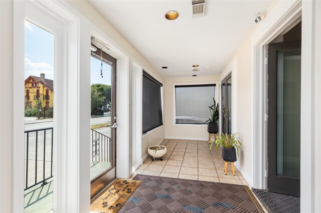 doorway with light tile patterned floors