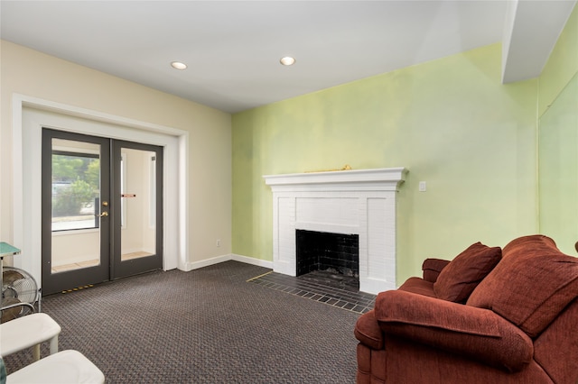 carpeted living room featuring french doors and a brick fireplace