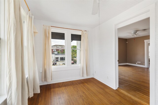 empty room with wood-type flooring and ceiling fan