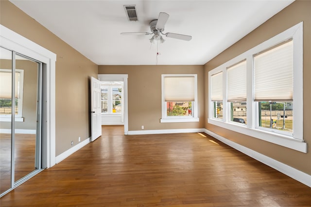 interior space featuring dark wood-type flooring and ceiling fan