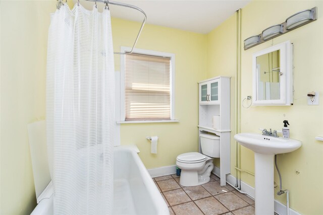 full bathroom with shower / bath combination with curtain, tile patterned flooring, toilet, and sink