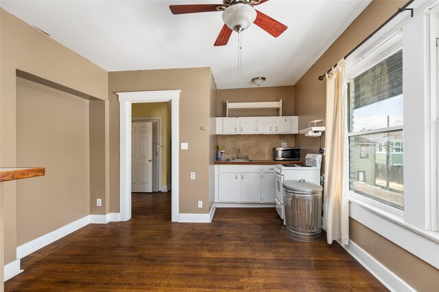 kitchen with backsplash, dark hardwood / wood-style flooring, white cabinetry, white electric stove, and ceiling fan