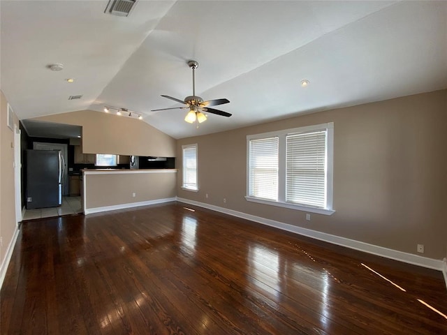 unfurnished living room featuring ceiling fan, lofted ceiling, and dark hardwood / wood-style floors