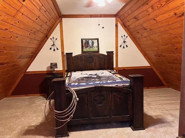 bedroom with light colored carpet, wooden ceiling, and vaulted ceiling