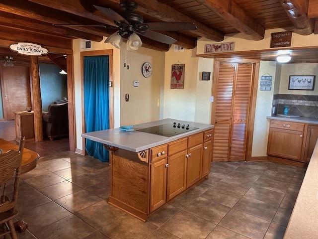 kitchen with black electric stovetop, ceiling fan, beam ceiling, wooden ceiling, and a kitchen island