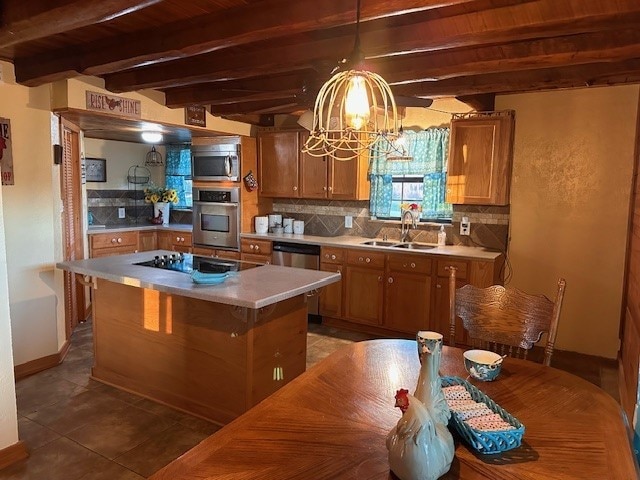 kitchen featuring sink, appliances with stainless steel finishes, beamed ceiling, a kitchen island, and wood ceiling