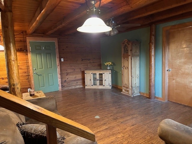 interior space featuring wood walls, beamed ceiling, wooden ceiling, and wood-type flooring