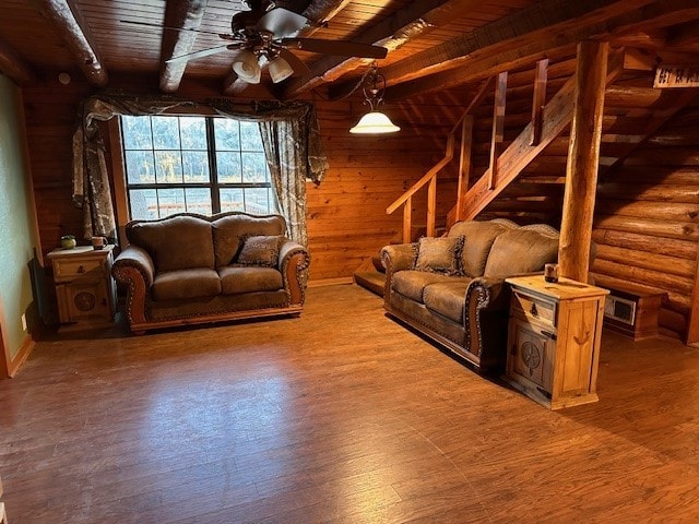 unfurnished living room with beam ceiling, rustic walls, and wooden ceiling