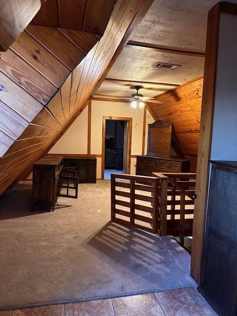 additional living space with ceiling fan, lofted ceiling, and a textured ceiling