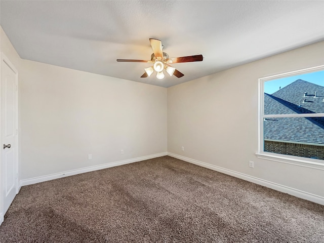 spare room featuring carpet and ceiling fan