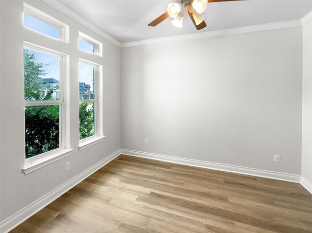 spare room with crown molding, hardwood / wood-style flooring, and ceiling fan