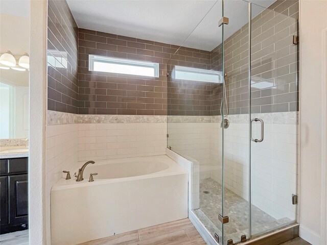 bathroom with vanity, hardwood / wood-style floors, and independent shower and bath