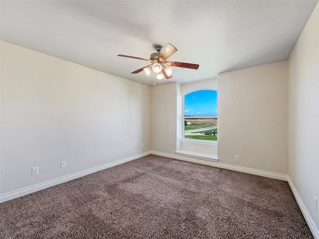 carpeted spare room featuring a textured ceiling and ceiling fan