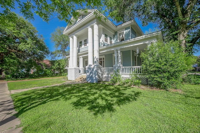 greek revival inspired property featuring a front yard and a porch