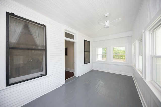 unfurnished sunroom featuring ceiling fan