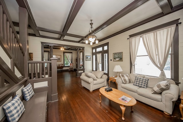 living room with coffered ceiling, beam ceiling, dark hardwood / wood-style floors, and a wealth of natural light