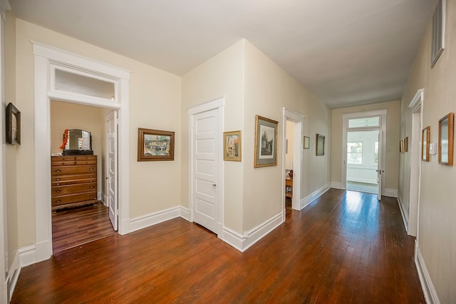 corridor featuring dark wood-type flooring