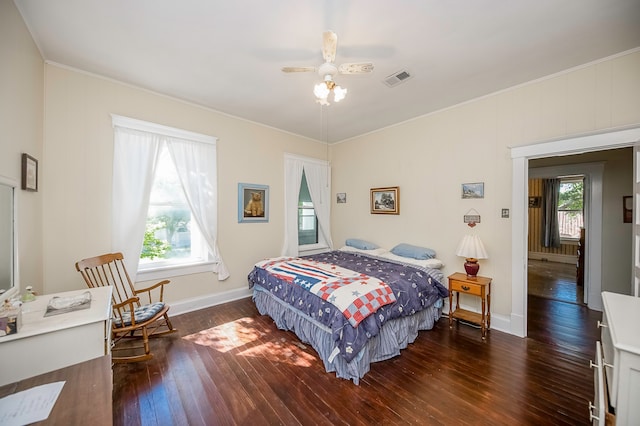 bedroom with ceiling fan, crown molding, and dark hardwood / wood-style flooring