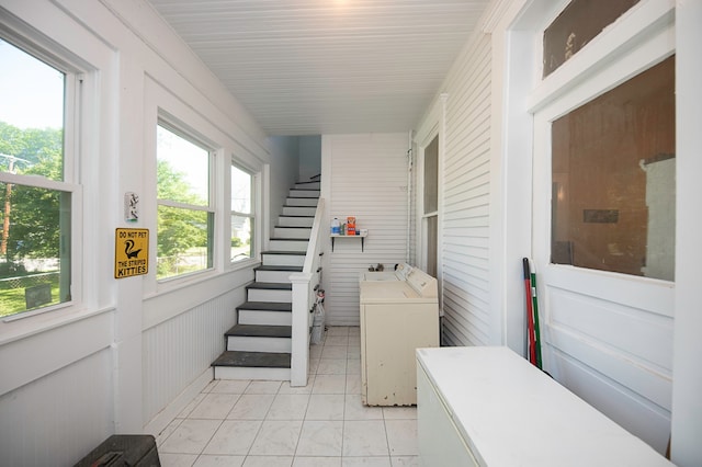 interior space with washing machine and dryer and wooden walls