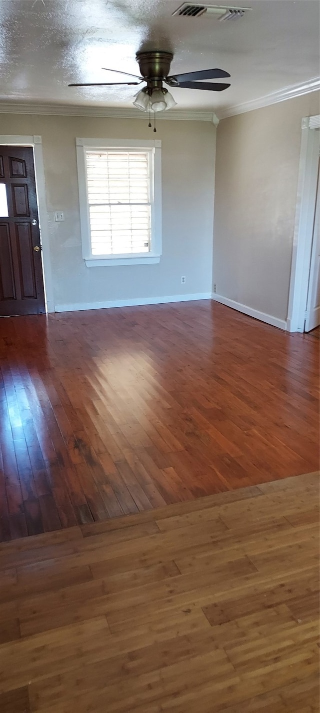 unfurnished room featuring ornamental molding, ceiling fan, and dark hardwood / wood-style floors