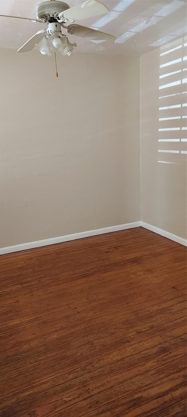 empty room with wood-type flooring and ceiling fan