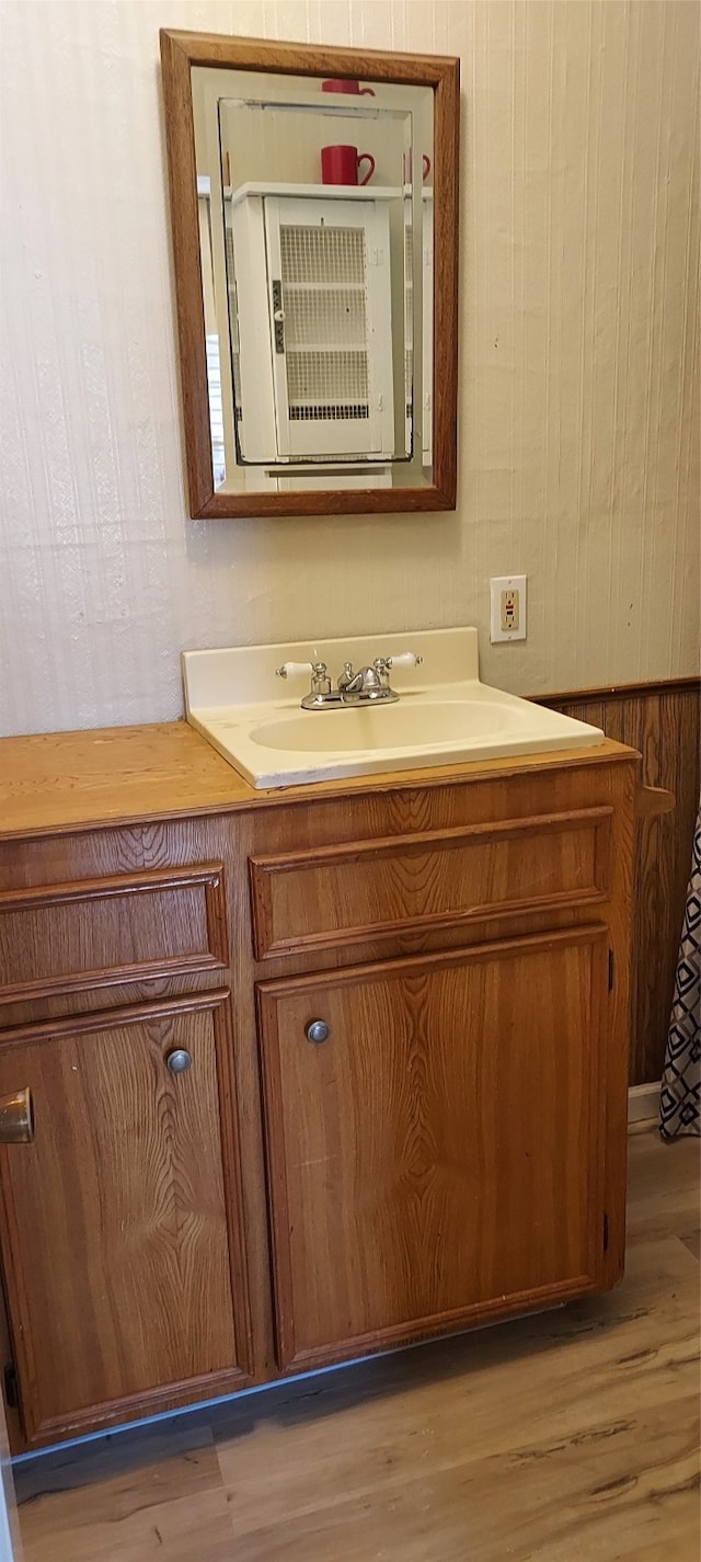 bathroom with oversized vanity and hardwood / wood-style floors