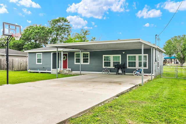 view of front facade with a carport and a front lawn