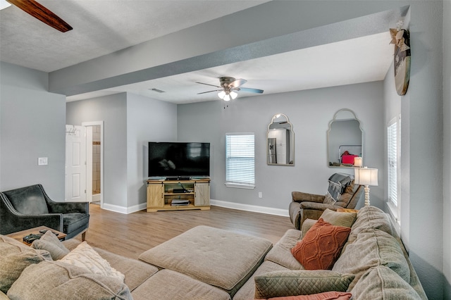 living room featuring light hardwood / wood-style floors and ceiling fan