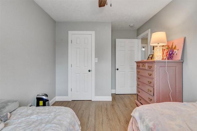 bedroom featuring light hardwood / wood-style floors and ceiling fan