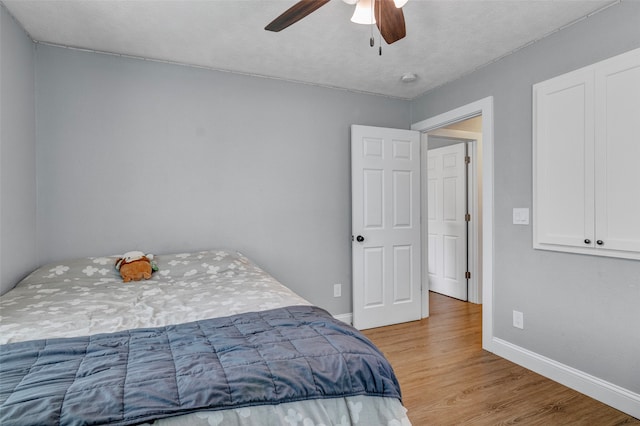 bedroom featuring ceiling fan and light hardwood / wood-style flooring