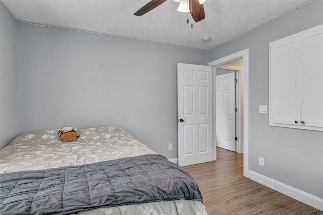 bedroom featuring ceiling fan and light hardwood / wood-style flooring