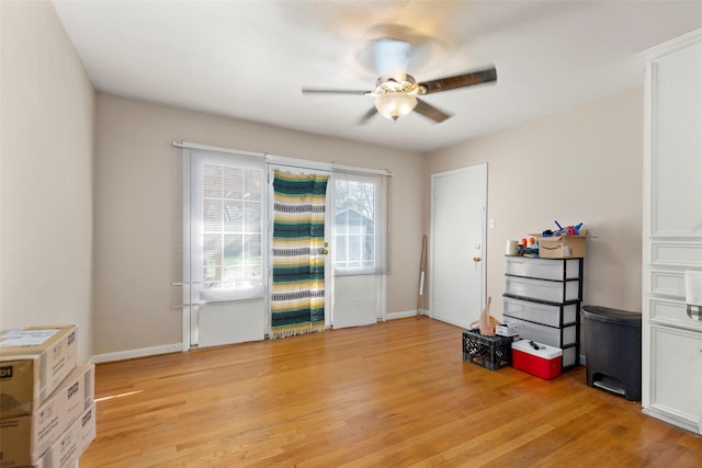 interior space with light wood-type flooring, ceiling fan, and baseboards