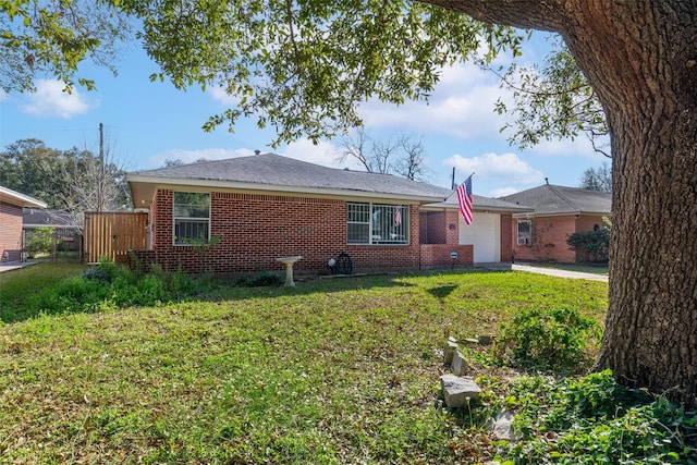 view of front facade featuring concrete driveway, brick siding, a front lawn, and an attached garage