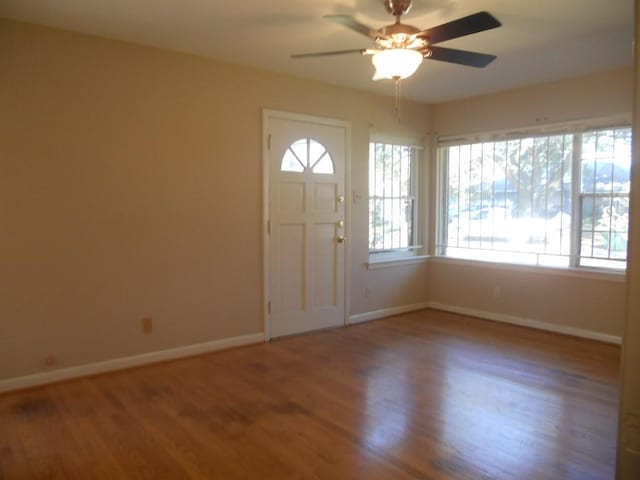 entryway with ceiling fan, baseboards, and wood finished floors
