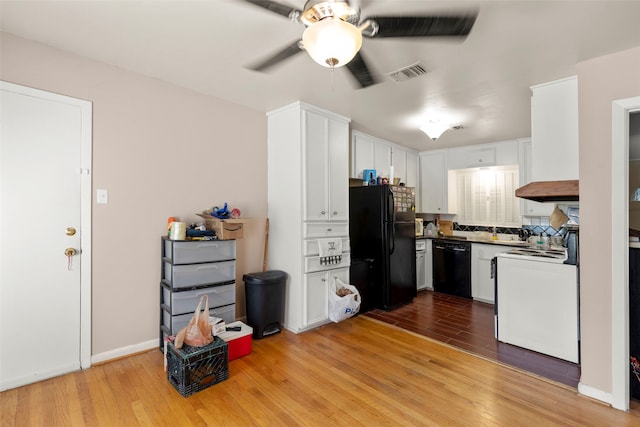 kitchen featuring white cabinetry, black appliances, light hardwood / wood-style flooring, and ceiling fan