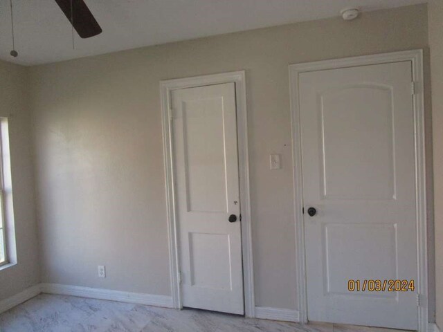 unfurnished bedroom featuring ceiling fan