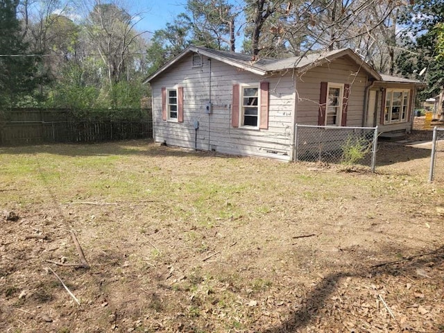 rear view of house featuring a yard