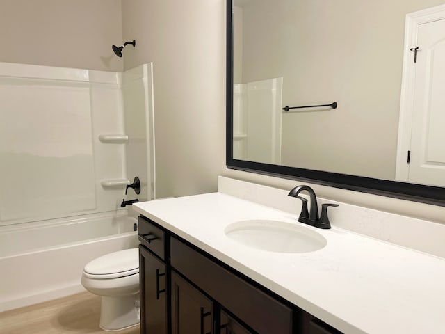 full bathroom featuring shower / tub combination, vanity, hardwood / wood-style flooring, and toilet