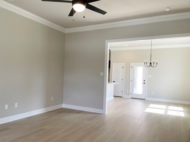 unfurnished room with crown molding, ceiling fan with notable chandelier, and light hardwood / wood-style floors