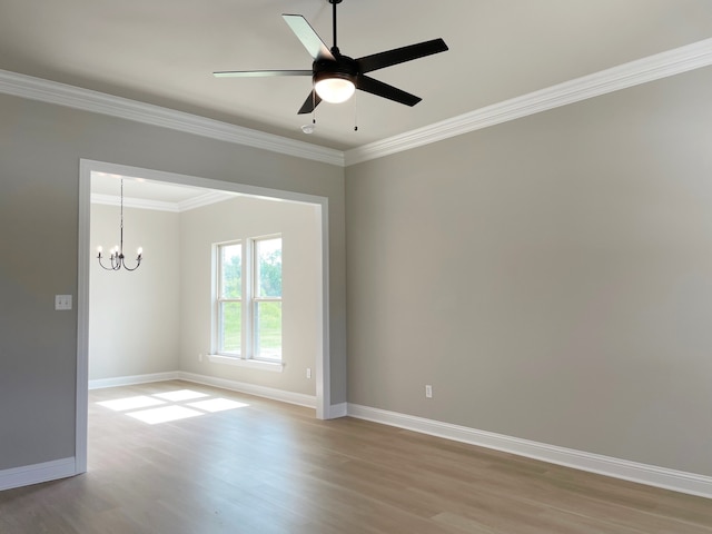 unfurnished room featuring hardwood / wood-style floors, crown molding, and ceiling fan with notable chandelier