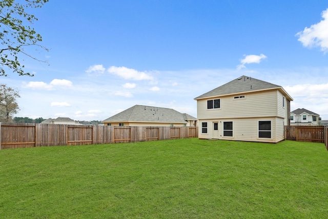 rear view of house featuring a lawn