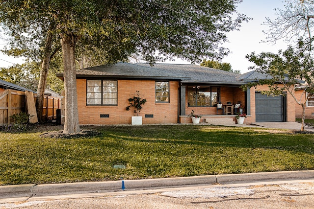 view of front of property with a front lawn and a garage