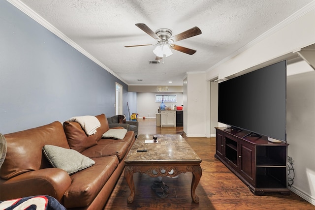 living room with a textured ceiling, ceiling fan, dark hardwood / wood-style floors, and crown molding