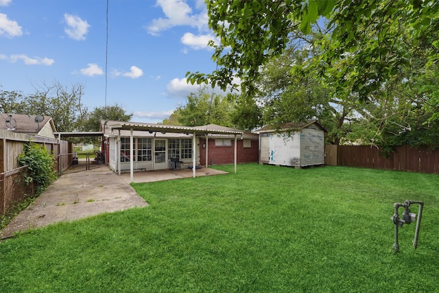 view of yard with a patio and a storage shed