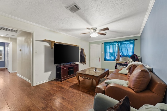 living room featuring dark hardwood / wood-style flooring, ceiling fan, a textured ceiling, and plenty of natural light