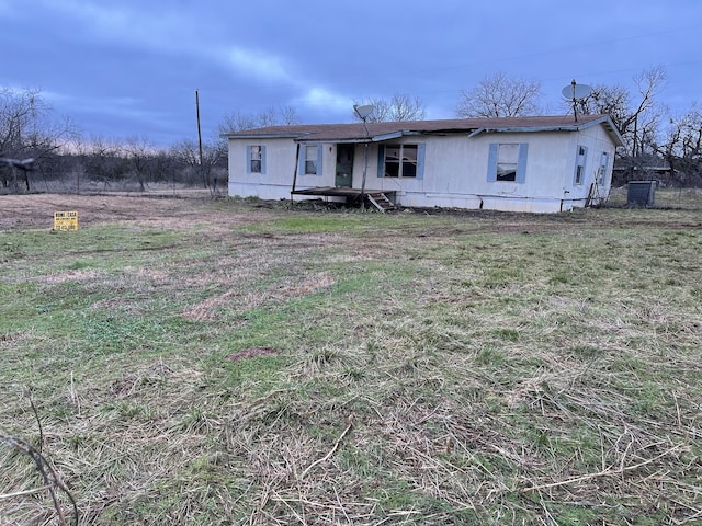 rear view of property featuring a yard